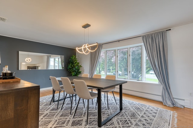32 Patriot Ln, Newington, CT 06111 - dining room with a baseboard heating unit and light wood-style flooring
