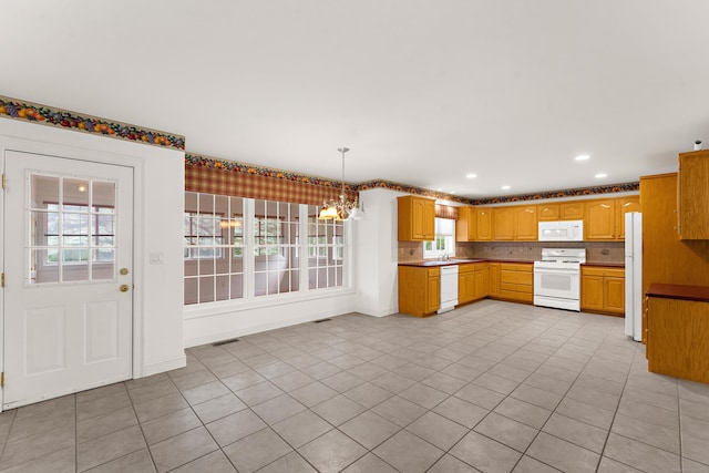 15 Sweet Meadow Dr, South Windsor, CT 06074 - kitchen with white appliances, a chandelier, healthy amount of natural light, tasteful backsplash, and recessed lighting