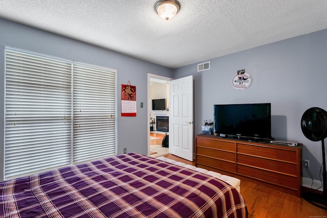 157 Carriage Crossing Ln Unit 157, Middletown, CT 06457 - bedroom with a textured ceiling and wood finished floors