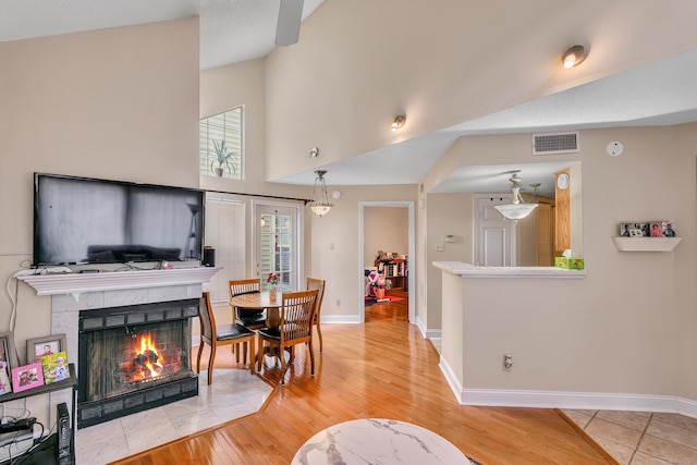 157 Carriage Crossing Ln Unit 157, Middletown, CT 06457 - living room featuring a premium fireplace, light wood-style flooring, and a high ceiling