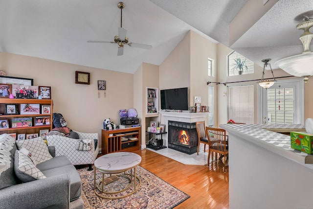 157 Carriage Crossing Ln Unit 157, Middletown, CT 06457 - living room featuring light wood-type flooring, high vaulted ceiling, ceiling fan, and a fireplace