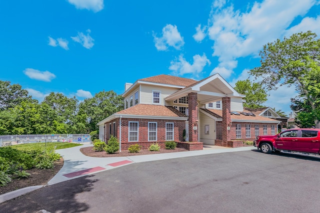 157 Carriage Crossing Ln Unit 157, Middletown, CT 06457 - view of front of home with brick siding, a shingled roof, and a chimney