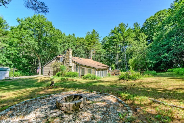 1668 N Rd, Killingly, CT 06241 - view of green lawn with an outdoor fire pit and a forest view