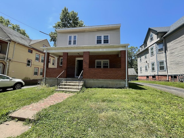 223 S Whitney St, Hartford, CT 06105 - view of front facade featuring a porch, a front yard, and brick siding