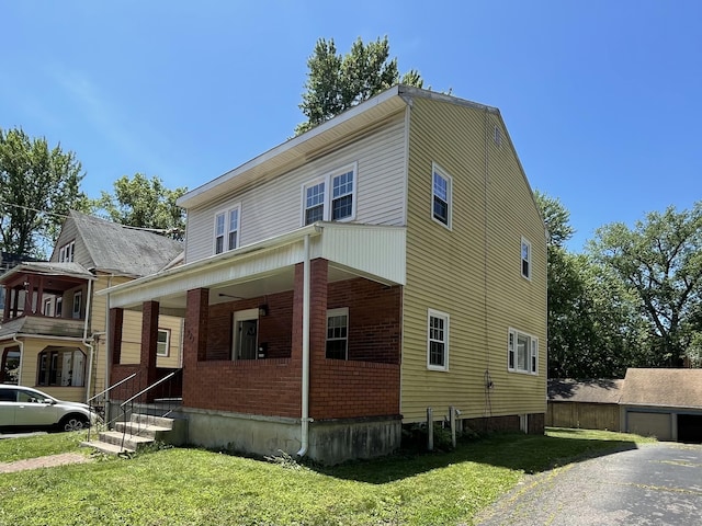 223 S Whitney St, Hartford, CT 06105 - view of front of house featuring covered porch, a front yard, and brick siding