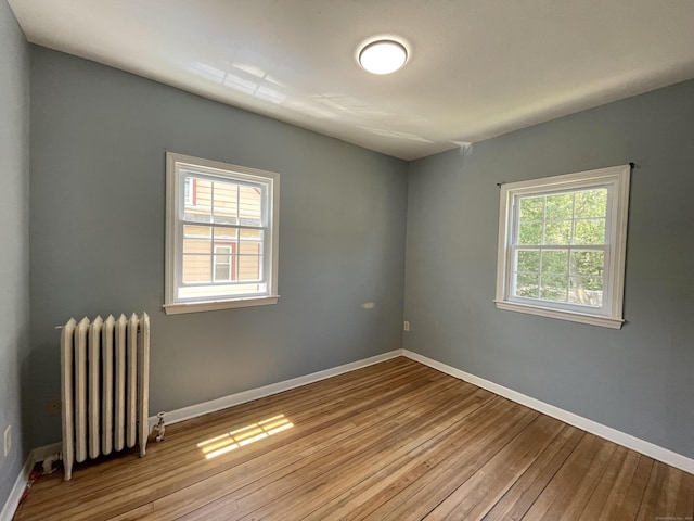 223 S Whitney St, Hartford, CT 06105 - empty room featuring radiator and hardwood / wood-style floors