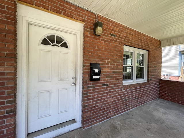 223 S Whitney St, Hartford, CT 06105 - view of exterior entry featuring brick siding and a porch