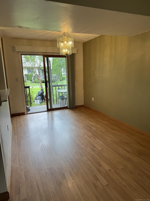 155 Cottonwood Rd Unit 155, Newington, CT 06051 - unfurnished living room featuring a chandelier and wood finished floors