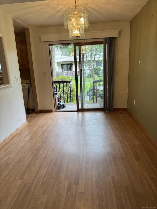 155 Cottonwood Rd Unit 155, Newington, CT 06051 - spare room featuring a chandelier and wood finished floors