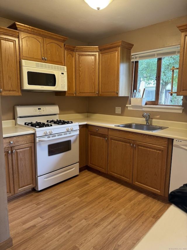 155 Cottonwood Rd Unit 155, Newington, CT 06051 - kitchen featuring white appliances, light wood-style flooring, light countertops, and brown cabinetry