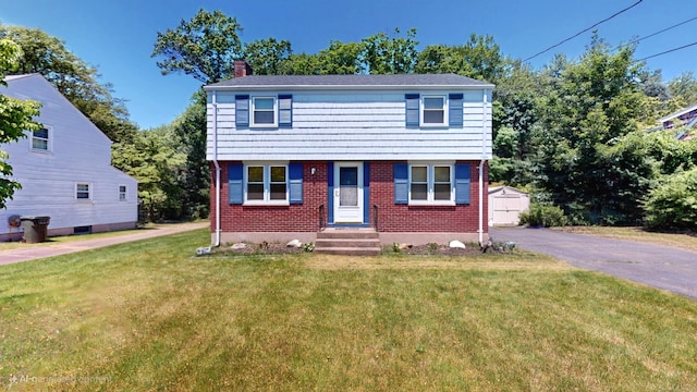 366 Hills St, East Hartford, CT 06118 - colonial house with a chimney, brick siding, and a front yard