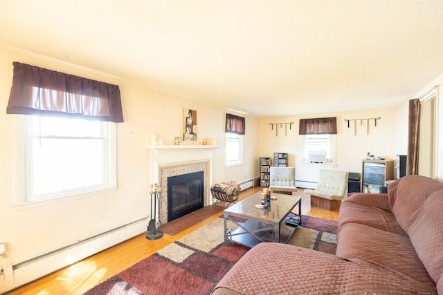 366 Hills St, East Hartford, CT 06118 - living room with baseboard heating, wood finished floors, and a fireplace with flush hearth