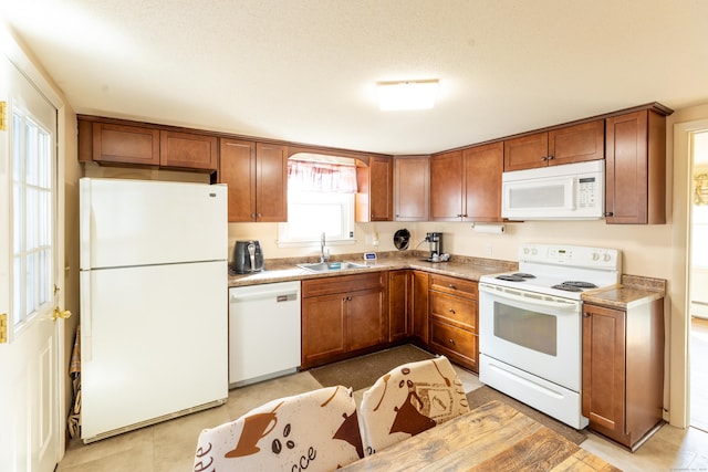 366 Hills St, East Hartford, CT 06118 - kitchen featuring white appliances, brown cabinetry, light countertops, and light tile patterned floors