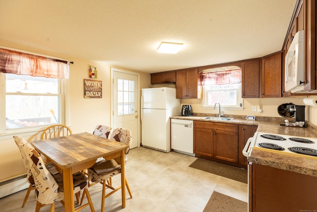 366 Hills St, East Hartford, CT 06118 - kitchen with white appliances, brown cabinetry, a baseboard radiator, and a textured ceiling