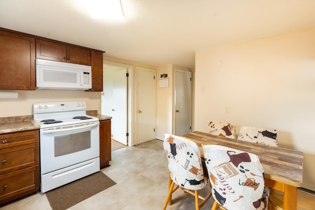 366 Hills St, East Hartford, CT 06118 - kitchen featuring white appliances and brown cabinetry