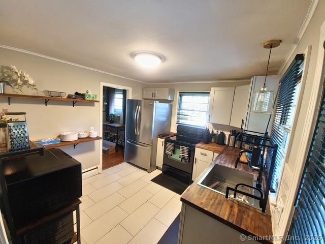 70 Ellsworth Dr, Bloomfield, CT 06002 - kitchen featuring wood counters, freestanding refrigerator, black range with electric stovetop, ornamental molding, and hanging light fixtures