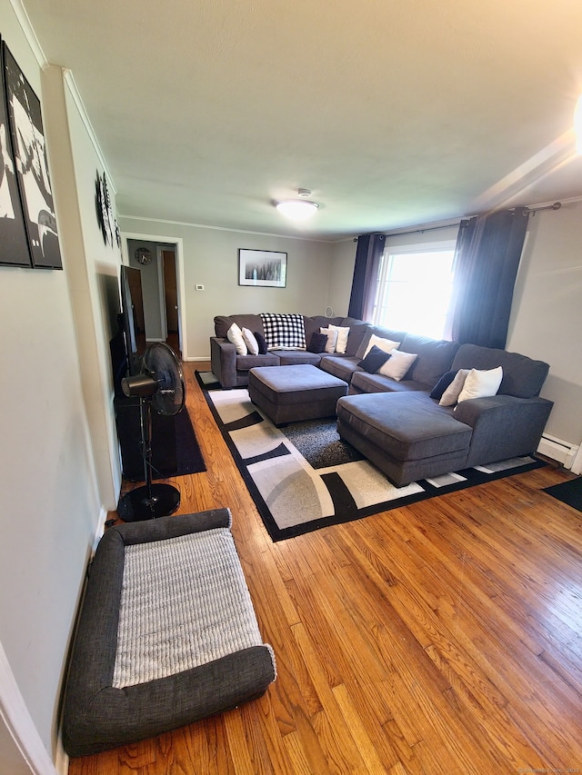 70 Ellsworth Dr, Bloomfield, CT 06002 - living area with wood finished floors, a baseboard heating unit, and crown molding