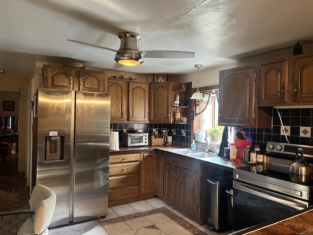 911 Matianuck Ave, Windsor, CT 06095 - kitchen featuring appliances with stainless steel finishes, backsplash, light tile patterned flooring, hanging light fixtures, and ceiling fan