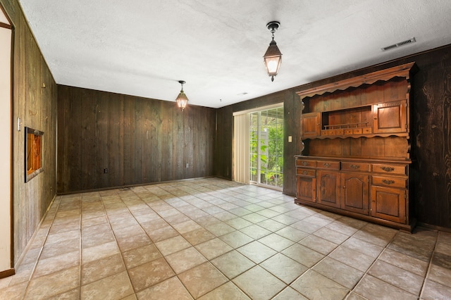 846 Long Hill Rd Unit 846, Middletown, CT 06457 - unfurnished dining area with wood walls and a textured ceiling