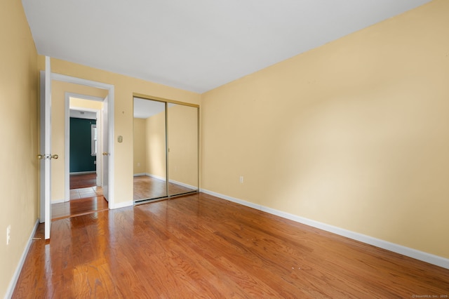 846 Long Hill Rd Unit 846, Middletown, CT 06457 - unfurnished bedroom featuring wood finished floors and a closet