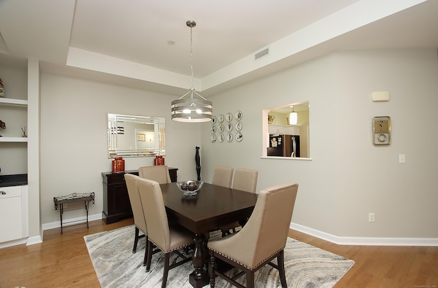 36 Todd St Unit 606, Hamden, CT 06518 - dining space featuring light wood-type flooring and a raised ceiling