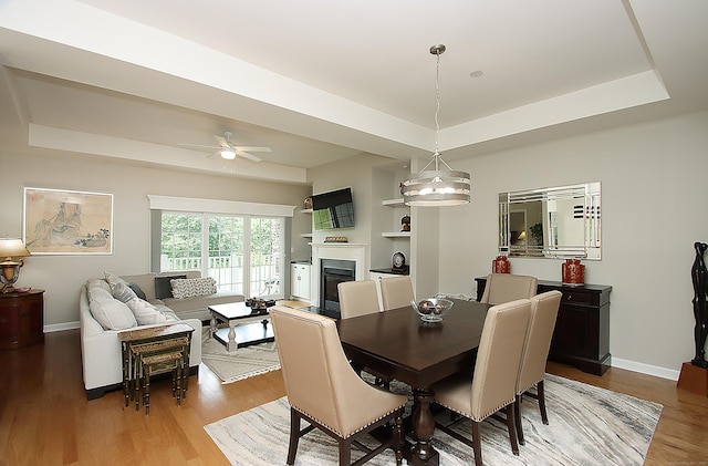 36 Todd St Unit 606, Hamden, CT 06518 - dining area featuring a raised ceiling, a glass covered fireplace, light wood finished floors, and a ceiling fan