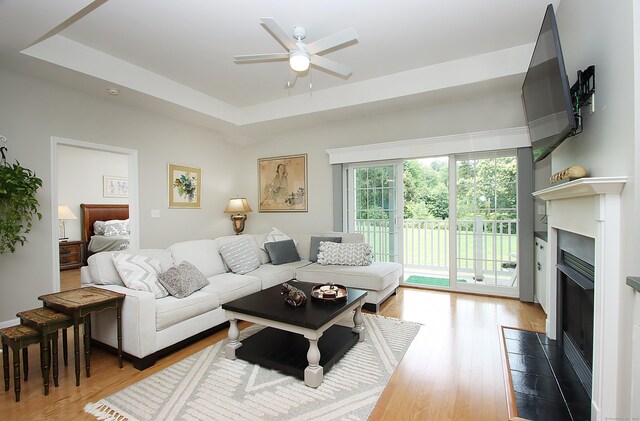 36 Todd St Unit 606, Hamden, CT 06518 - living room with a fireplace with flush hearth, ceiling fan, wood finished floors, and a tray ceiling