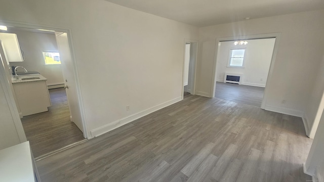 83 Mulberry St, Stamford, CT 06907 - unfurnished room with wood finished floors, healthy amount of natural light, and a baseboard heating unit