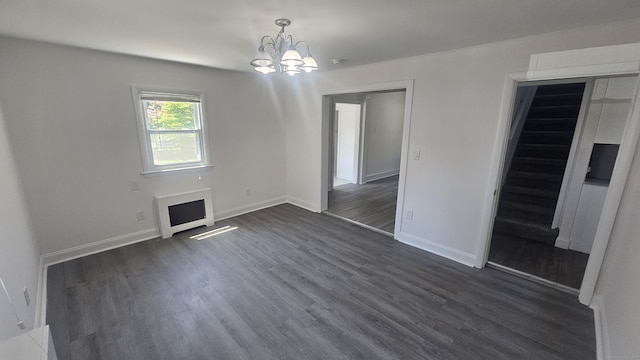 83 Mulberry St, Stamford, CT 06907 - unfurnished living room featuring a chandelier, dark wood-type flooring, heating unit, and a fireplace