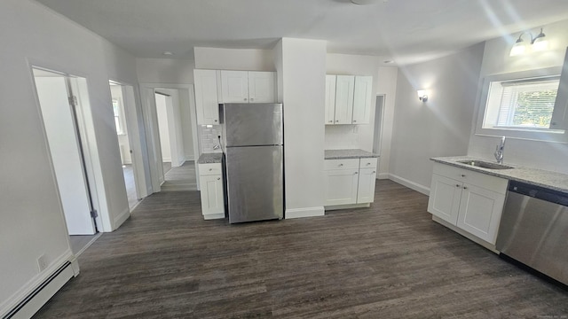 83 Mulberry St, Stamford, CT 06907 - kitchen with appliances with stainless steel finishes, baseboard heating, tasteful backsplash, white cabinetry, and light stone countertops