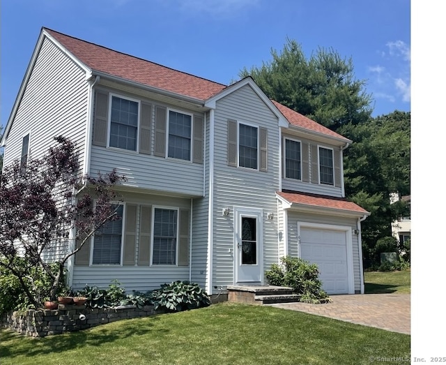 63 Lucy Cir, Wallingford, CT 06492 - view of front of home featuring a front lawn, a garage, and decorative driveway