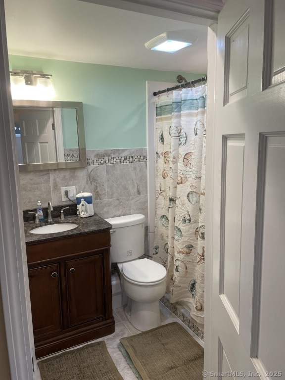 63 Lucy Cir, Wallingford, CT 06492 - bathroom featuring vanity, tile walls, and curtained shower