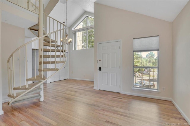 49 Carriage Crossing Ln Unit 49, Middletown, CT 06457 - foyer entrance with a chandelier, wood finished floors, stairway, and high vaulted ceiling