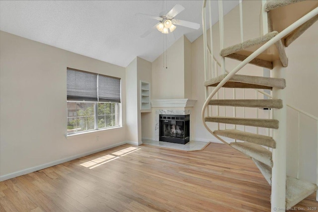 49 Carriage Crossing Ln Unit 49, Middletown, CT 06457 - unfurnished living room with high vaulted ceiling, stairs, wood finished floors, ceiling fan, and a fireplace