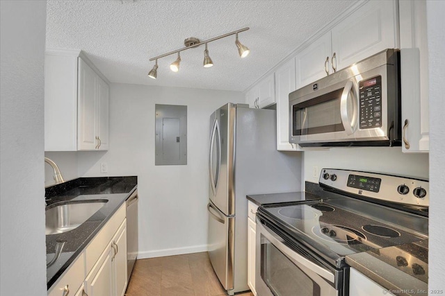 49 Carriage Crossing Ln Unit 49, Middletown, CT 06457 - kitchen featuring appliances with stainless steel finishes, electric panel, white cabinets, a textured ceiling, and dark stone countertops