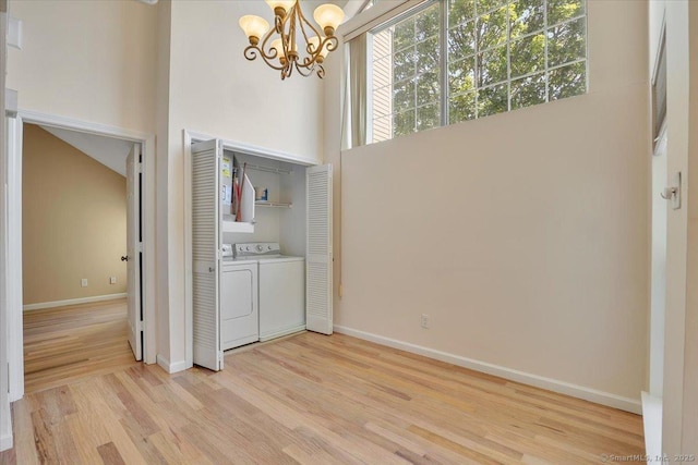 49 Carriage Crossing Ln Unit 49, Middletown, CT 06457 - laundry room with washer and clothes dryer, a chandelier, light wood finished floors, and a high ceiling