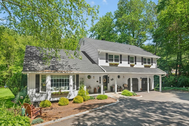 136 Knorr Rd, Monroe, CT 06468 - view of front facade featuring driveway, an attached garage, covered porch, and a shingled roof
