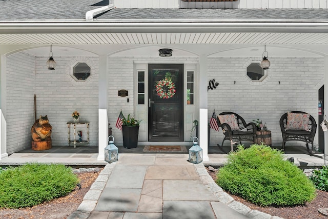 136 Knorr Rd, Monroe, CT 06468 - entrance to property featuring brick siding, covered porch, and a shingled roof