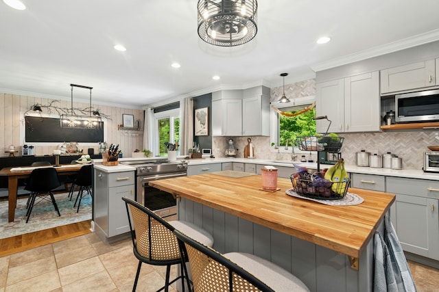 136 Knorr Rd, Monroe, CT 06468 - kitchen with stainless steel appliances, gray cabinets, plenty of natural light, butcher block counters, and ornamental molding