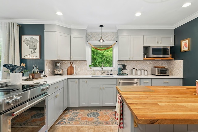 136 Knorr Rd, Monroe, CT 06468 - kitchen with appliances with stainless steel finishes, butcher block countertops, tasteful backsplash, ornamental molding, and recessed lighting