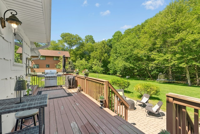 136 Knorr Rd, Monroe, CT 06468 - wooden deck with a trampoline, a lawn, a patio area, and area for grilling