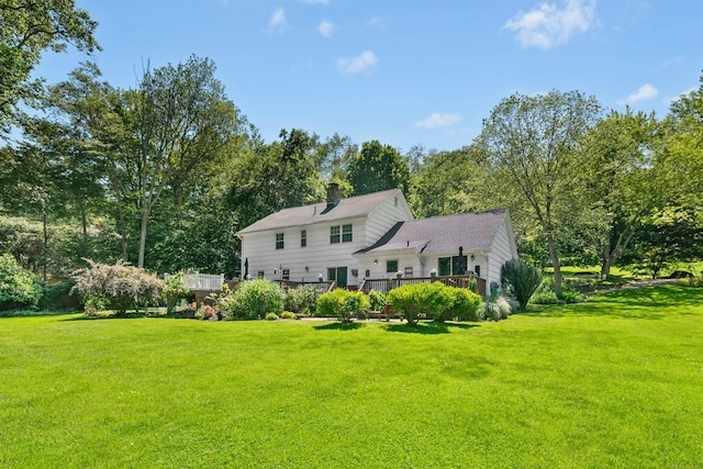 136 Knorr Rd, Monroe, CT 06468 - rear view of property with a yard, a wooden deck, a chimney, and view of scattered trees