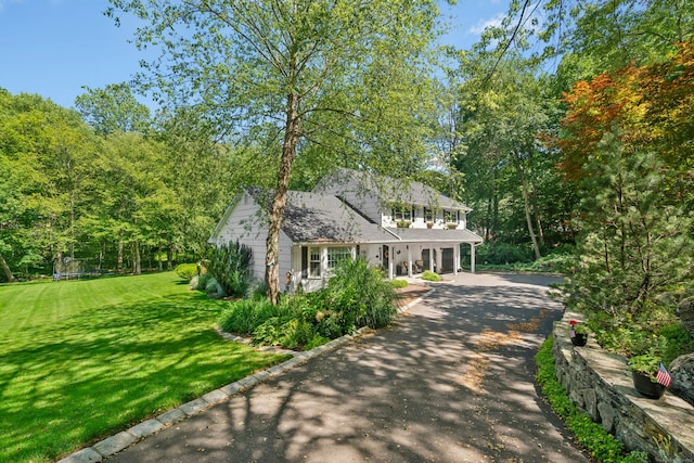 136 Knorr Rd, Monroe, CT 06468 - view of front of property with a trampoline, a front lawn, driveway, and a porch
