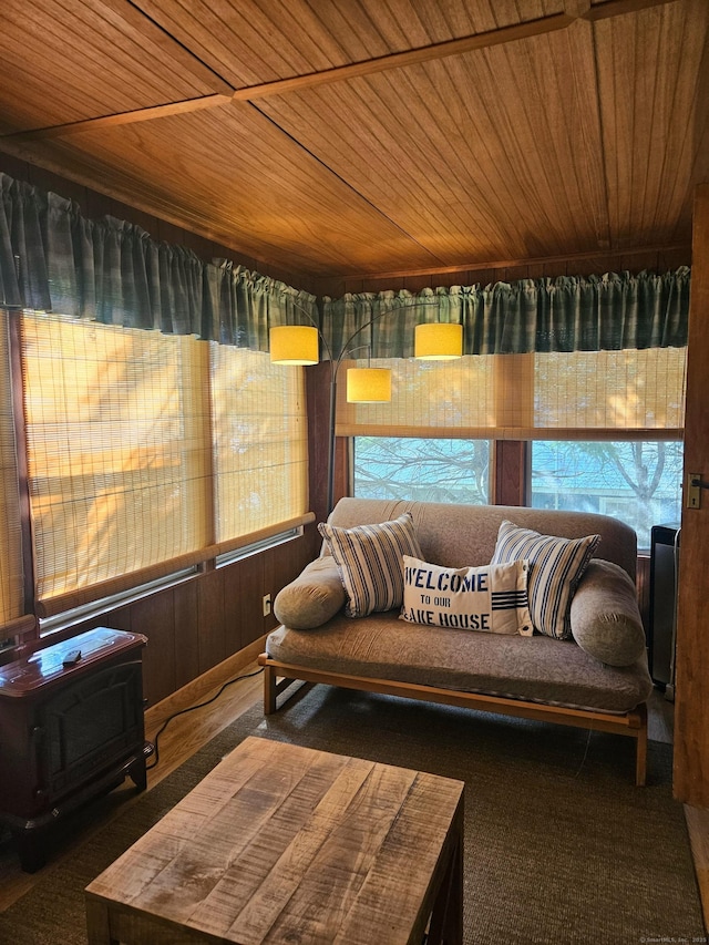 15 Ledge Rd, Lebanon, CT 06249 - sunroom with wood ceiling, plenty of natural light, a wood stove, carpet flooring, and wood walls