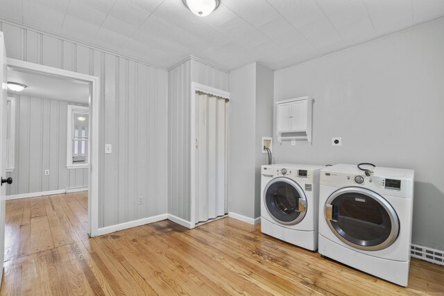 143 Jewett St, Ansonia, CT 06401 - laundry area featuring washing machine and clothes dryer, light wood finished floors, and a baseboard heating unit