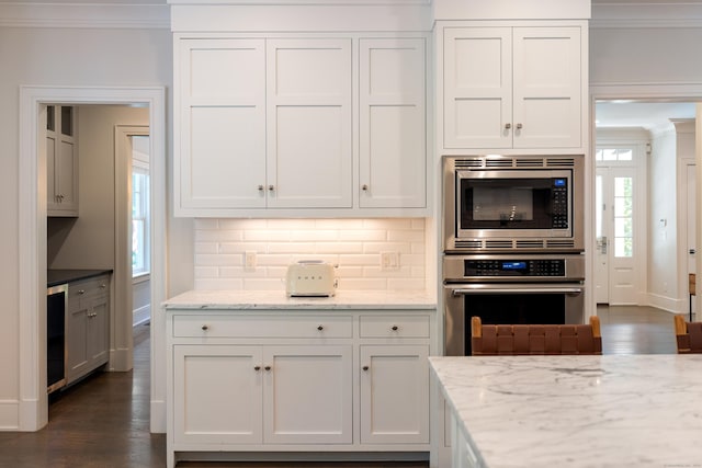 74 Brookside Rd, Darien, CT 06820 - kitchen featuring stainless steel appliances, ornamental molding, decorative backsplash, dark wood-style floors, and white cabinets