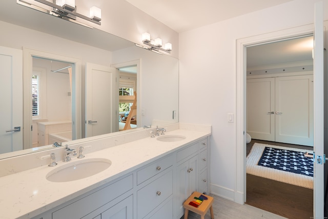 74 Brookside Rd, Darien, CT 06820 - full bathroom with double vanity and wood finished floors