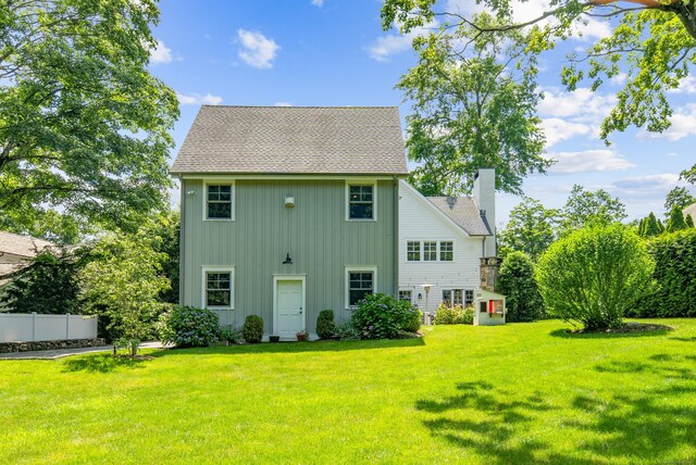 74 Brookside Rd, Darien, CT 06820 - back of property featuring board and batten siding, a shingled roof, and a chimney