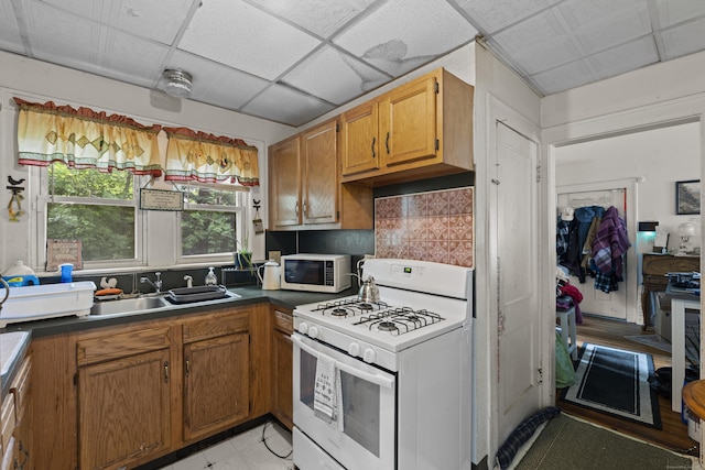 96 Melbourne Ter, Waterbury, CT 06704 - kitchen featuring white appliances, brown cabinetry, decorative backsplash, and dark countertops