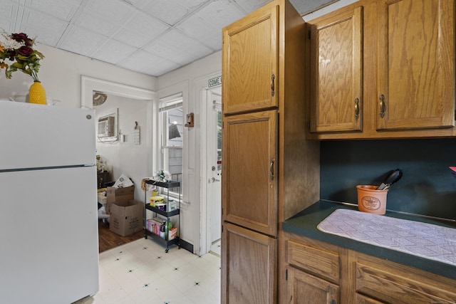 96 Melbourne Ter, Waterbury, CT 06704 - kitchen with freestanding refrigerator, light flooring, brown cabinetry, and a wall mounted air conditioner